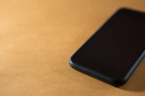 istock Selective focus of Smartphone on orange background and copy space 1180112315