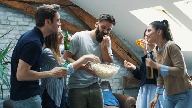istock Girl feeding her friend with popcorn 1180112395