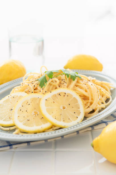 istock Cream pasta with a slice of lemon 1180112730