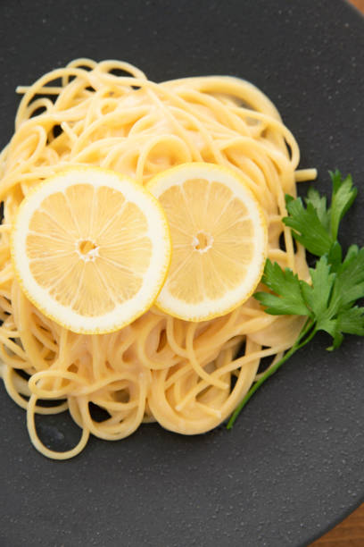 istock Cream pasta with a slice of lemon 1180112734