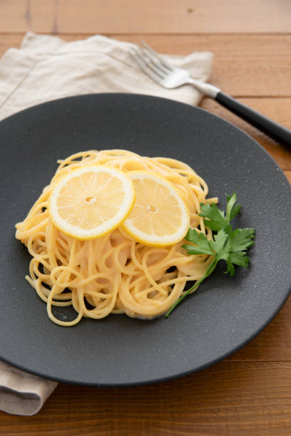 istock Cream pasta with a slice of lemon 1180112739