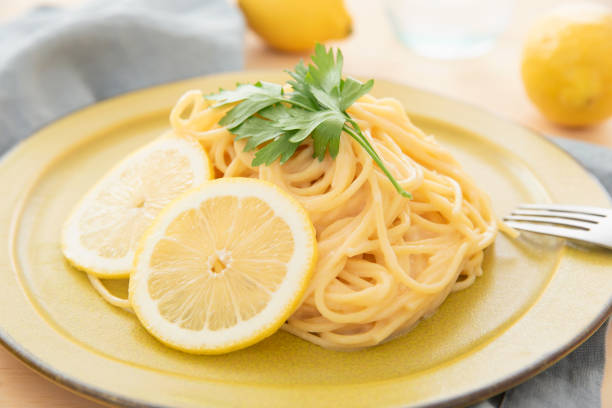 istock Cream pasta with a slice of lemon 1180112741