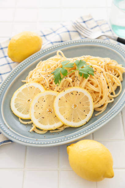 istock Cream pasta with a slice of lemon 1180112743