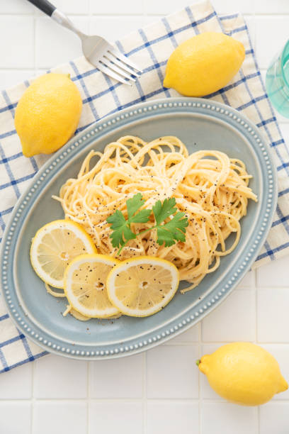 istock Cream pasta with a slice of lemon 1180112744