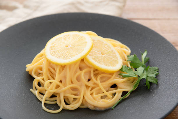 istock Cream pasta with a slice of lemon 1180112750