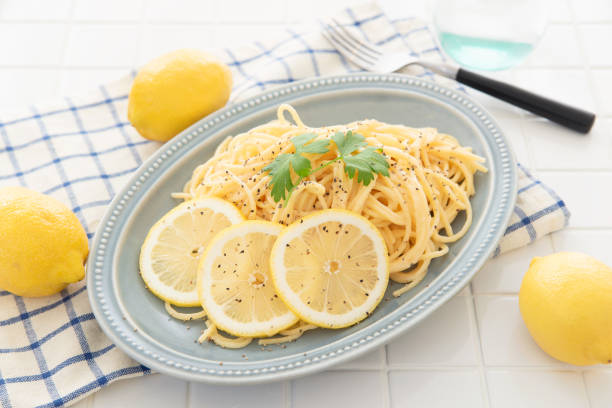 istock Cream pasta with a slice of lemon 1180112752