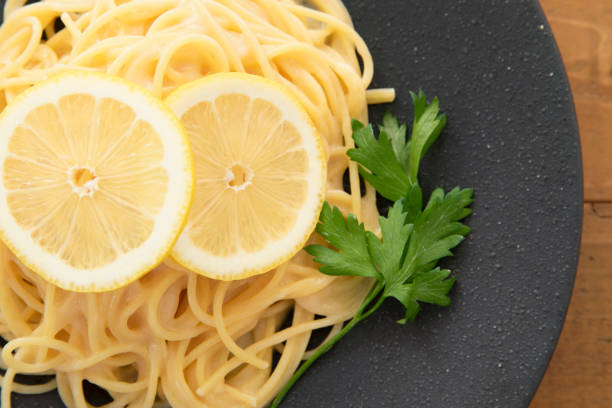 istock Cream pasta with a slice of lemon 1180112760