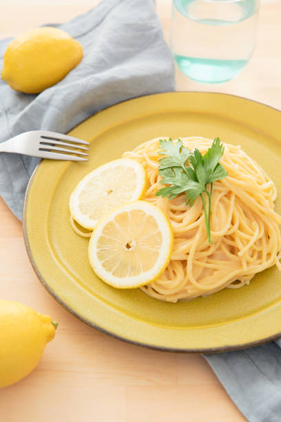 istock Cream pasta with a slice of lemon 1180112764