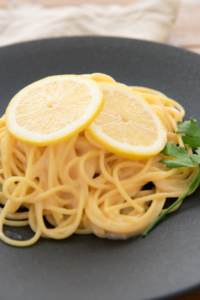 istock Cream pasta with a slice of lemon 1180112770