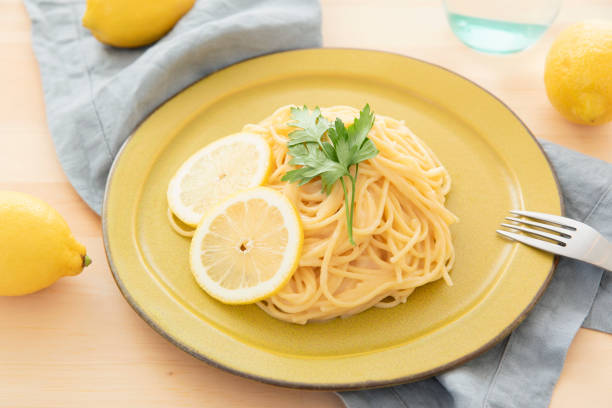 istock Cream pasta with a slice of lemon 1180112774