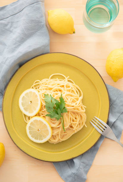 istock Cream pasta with a slice of lemon 1180112776