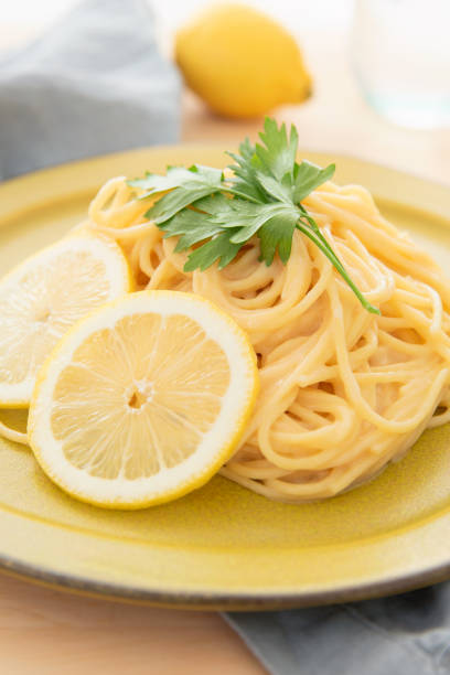 istock Cream pasta with a slice of lemon 1180112780