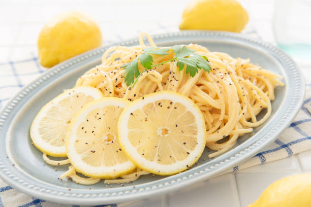 istock Cream pasta with a slice of lemon 1180112786