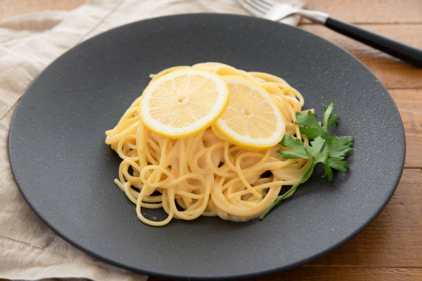 istock Cream pasta with a slice of lemon 1180112790