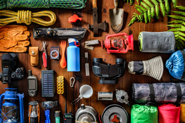 Top view camping and hiking travel and hiking gear, equipment and accessories for mountain trips Camping and hiking themes: Top view of large group of gear, equipment and accessories for mountain trips. survival tools stock pictures, royalty-free photos & images