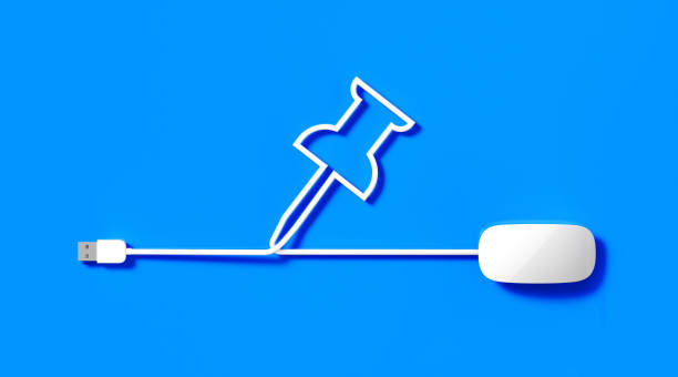 istock White Mouse Cable Forming A Thumb Tack Symbol on Blue Background 1180127600