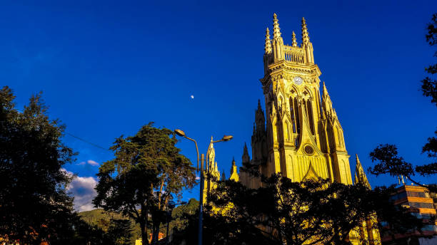 istock Catholic church in blue sky and the moon 1180130825