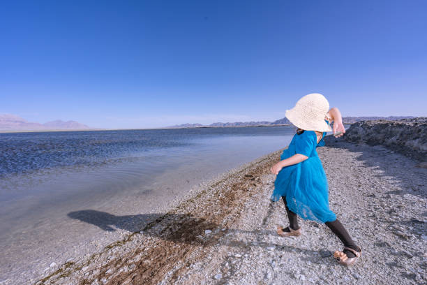 istock a young girl playing by the lake side 1180130853
