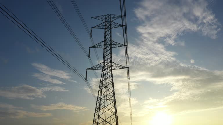 Dolly shot electricity pylons with sunrise