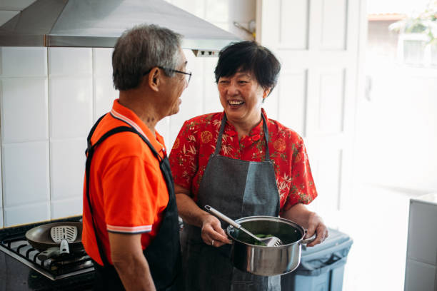 istock Lovely senior couple having fun in the kitchen 1180139993