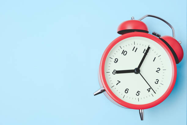 istock Red vintage alarm Clock show 8 O'Clock with copy space on light blue background 1180140853