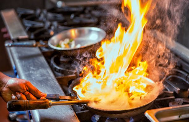 istock Flambe flame food frying pan 1180142182