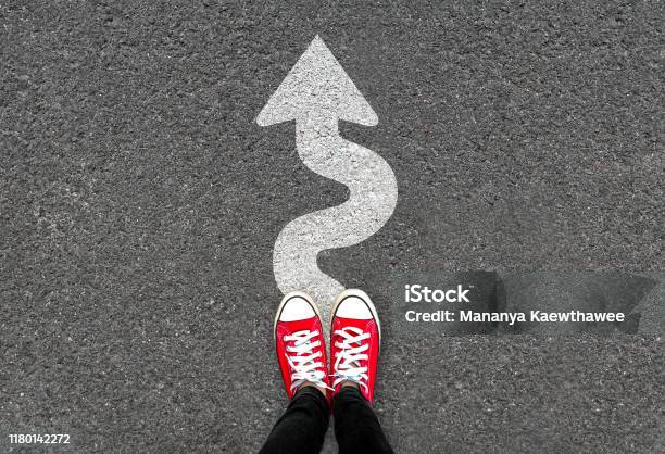 Feet And White Arrow Sign Go Straight On Road Background Top View Of Woman Forward Movement And Motivation Idea Concept Stock Photo - Download Image Now