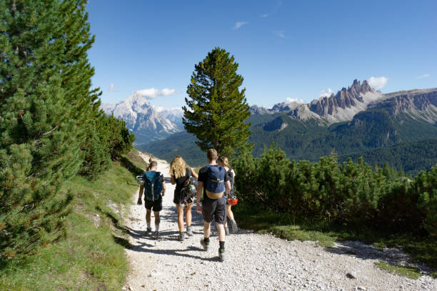 istock climbers walking down a road in a Dolomite mountain landscape after a hard climb 1180143981