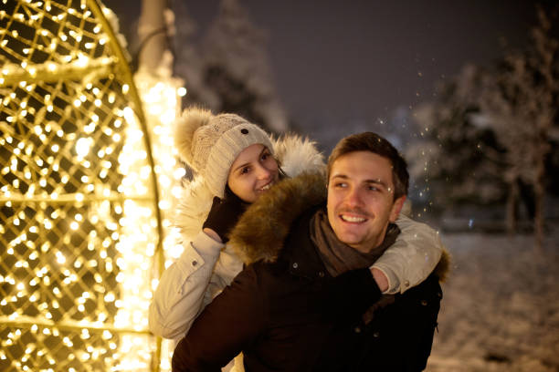 istock Man carrying his girlfriend on his back with a smile 1180148175