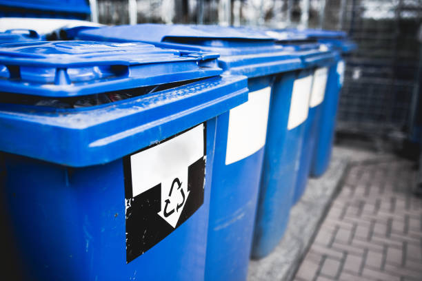 istock set lot of plastic recycle sort filter garbage trash cans on side of road,trash bin selective focus  . Plastic recycle bin in the public place . Blue container soft focus and blur background 1180148502