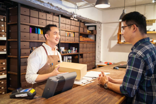 Salesman and customer talking in a shoe store.