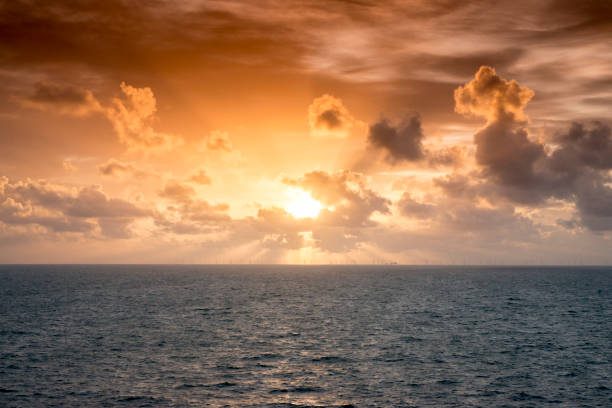 Sunset over offshore wind farm - green power generation