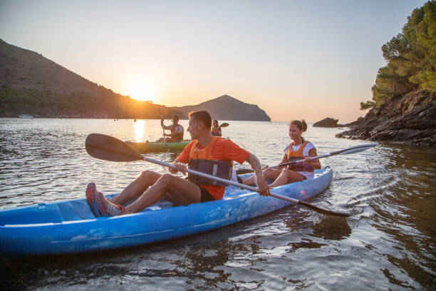 istock Kayakers Nearing Shore as Sun Sets Over Mediterranean 1180151352