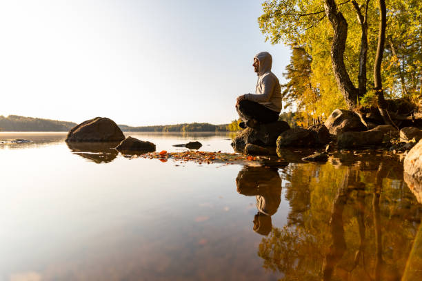istock Man looking out over a lake 1180155711