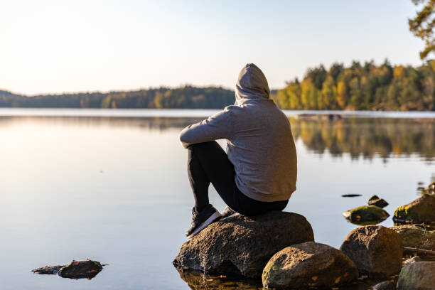 Man looking out over a lake