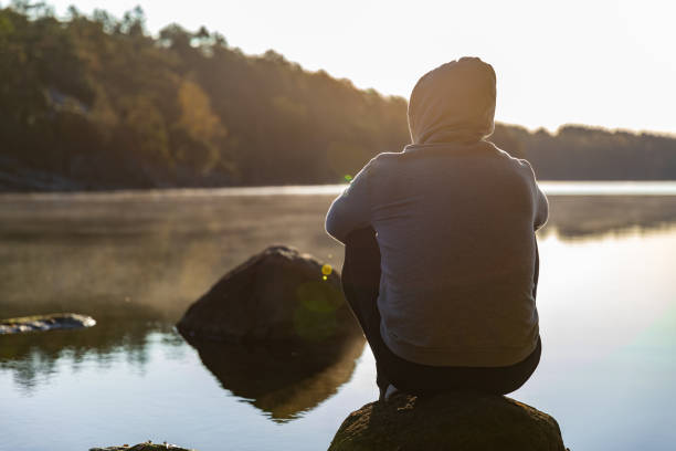 istock Man looking out over a lake 1180155730