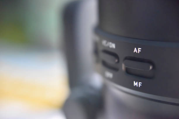 istock selective focus on switch of auto and manual focus on the black lense for camera 1180157154