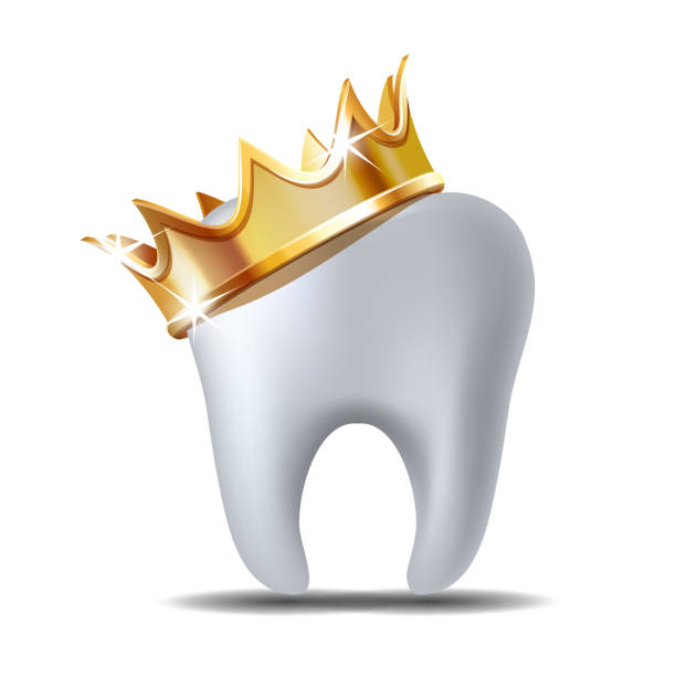 istock Realistic white Tooth in golden crown isolated on white 1180159051