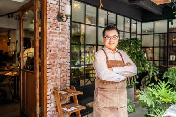istock Confident Asian shop owner 1180159926