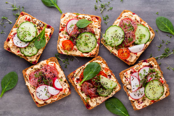 istock Sandwiches with cream cheese, vegetables and salami. 1180163254