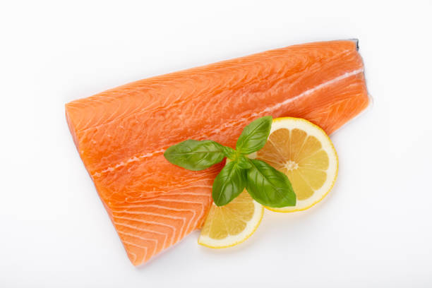 istock Fresh raw salmon fillets with herbs and lemon isolated on white background. 1180163510