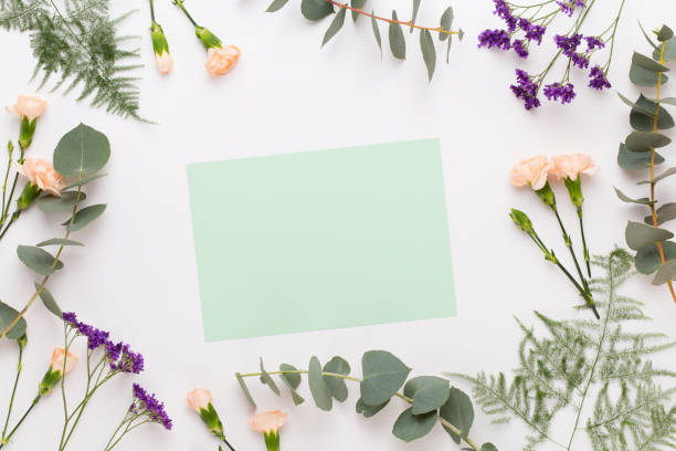istock Flowers composition. Paper blank, carnation flowers, eucalyptus branches on pastel  background. Flat lay, top view, copy spaceFlat lay stiil life. 1180164116