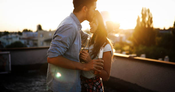 istock Couple flirting while having a drink on rooftop terrasse 1180165488