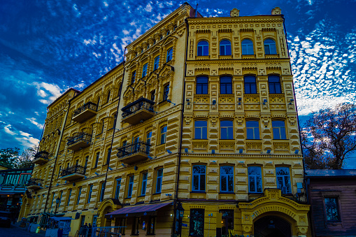 Kiev: Andriyivskyy Uzvoz Descent or Spusk with yellow building with old architecture and balconies