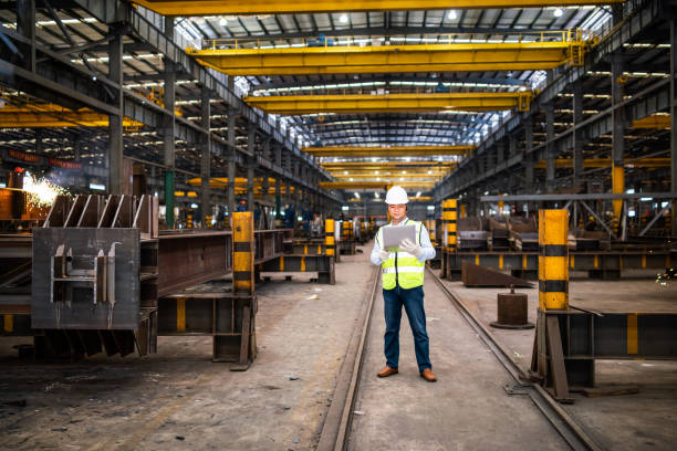 istock Asian engineer using a laptop in a factory 1180168997