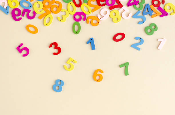istock Colored wooden numbers composition on beige background. 1180169108