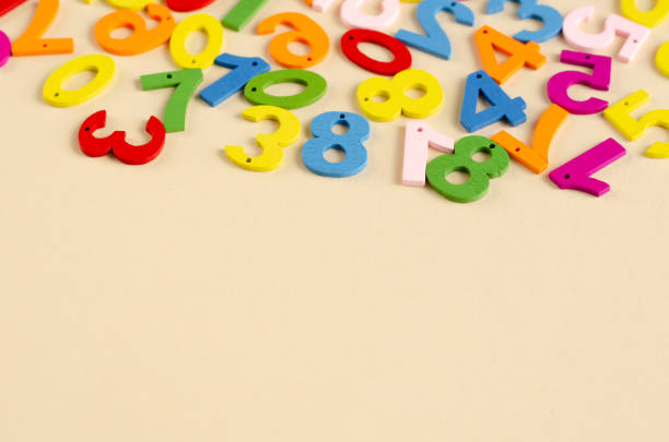 istock Colored wooden numbers composition on beige background. 1180169136