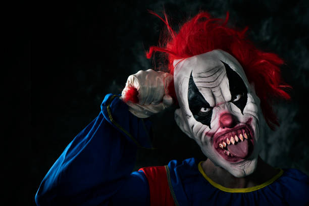 istock scary evil clown sticking out his tongue 1180169752