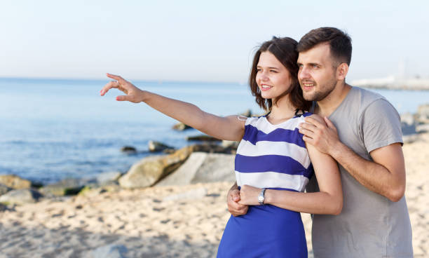 istock Young couple pointing to something interesting 1180170392
