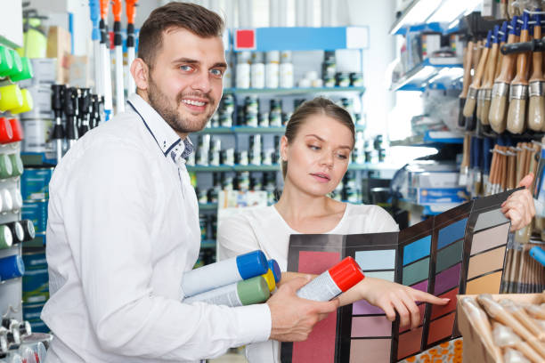 istock Happy man and woman  using palette scheme 1180170702